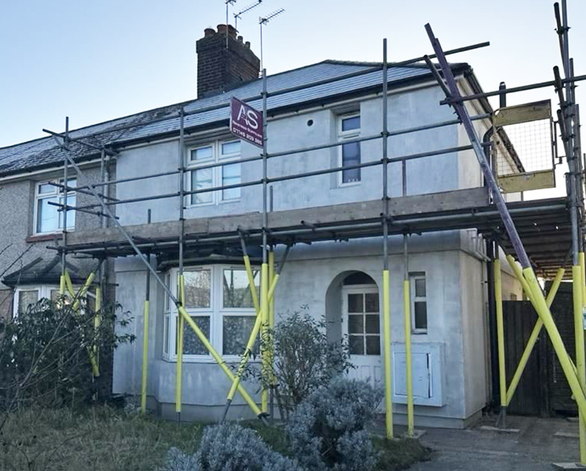 Armstrong Scaffolding erected around a brick building in Kent with workers in high-vis vests
