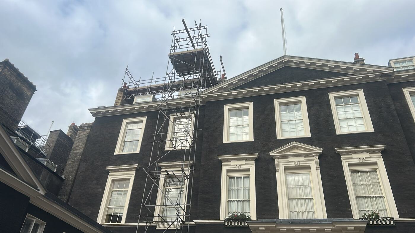 Scaffold hoist tower on a Georgian building in Piccadilly with a cantilevered loading platform projecting above roof level