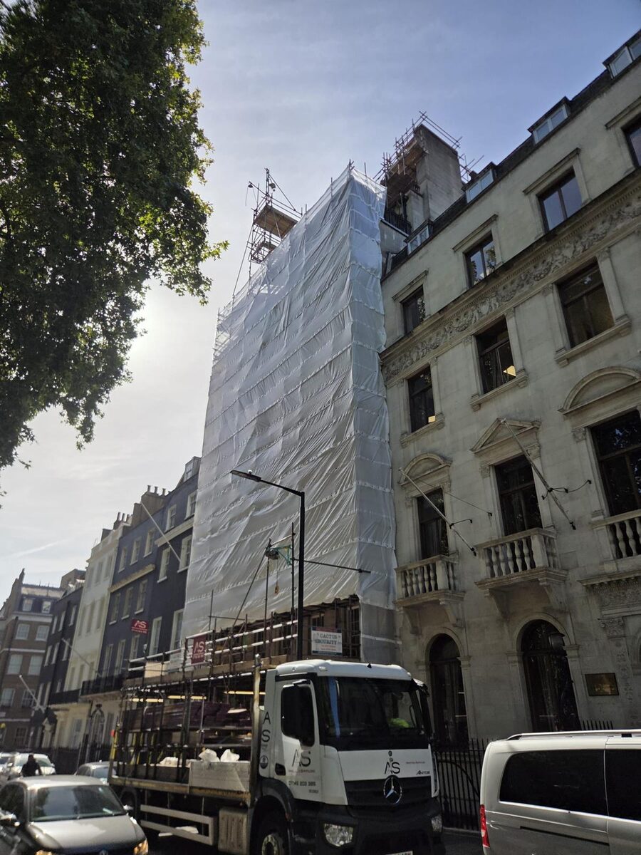 Armstrong Scaffolding branded lorry loaded with boards and tube parked on Berkeley Square beside the encapsulated scaffold