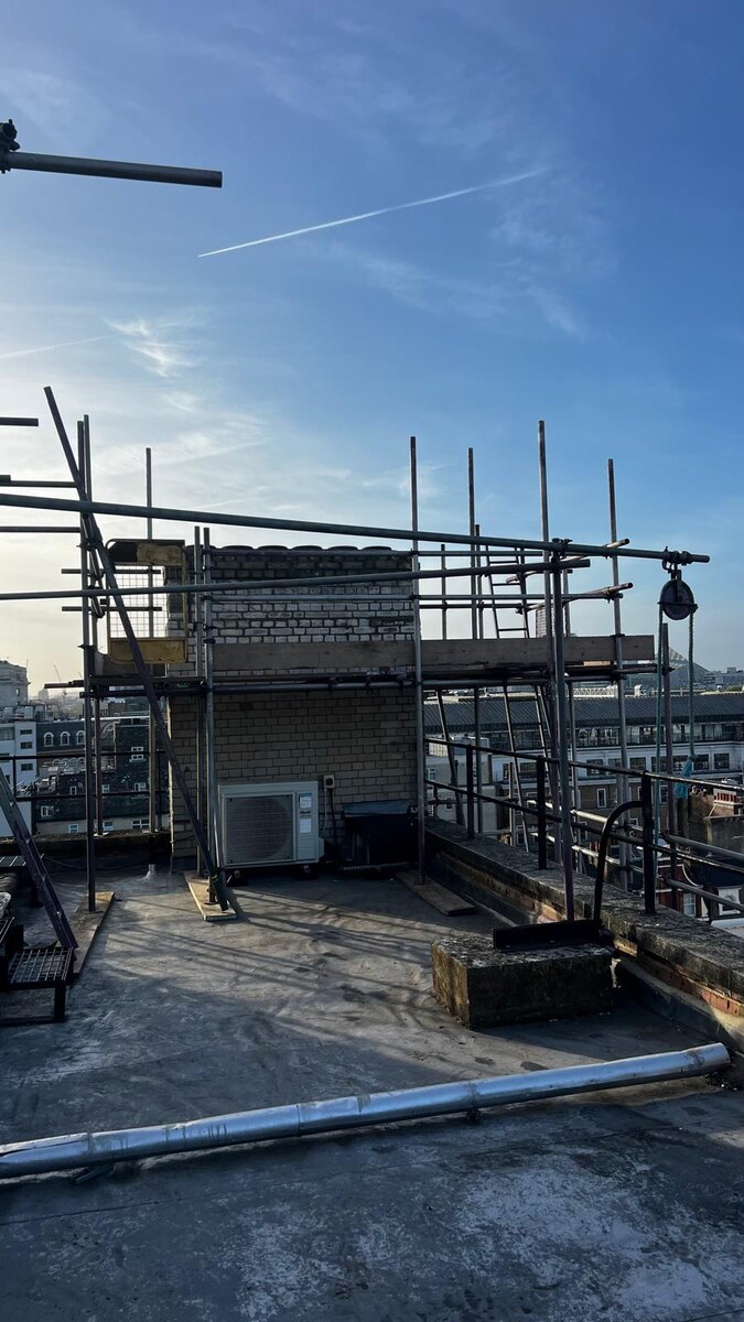 Armstrong Scaffolding tube and fitting scaffold erected around chimney stacks and rooftop plant on a Berkeley Square building