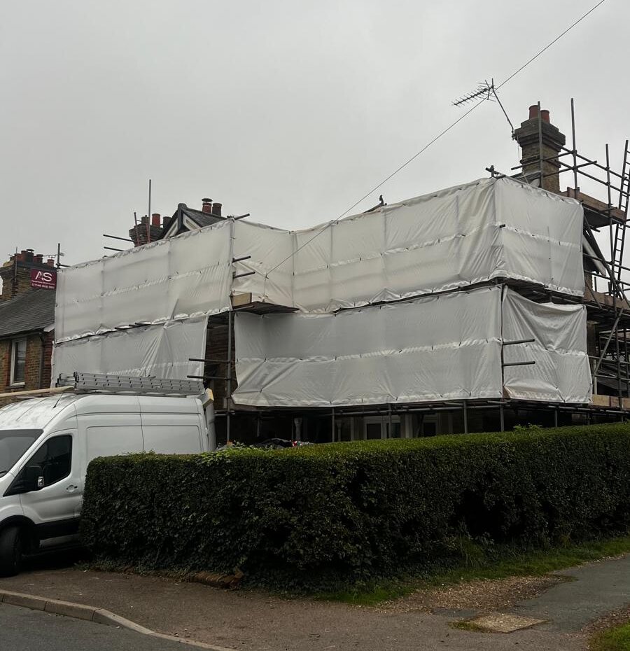 Fully encapsulated shrink wrap scaffold on a period property in Sevenoaks for a stone cleaning contract, with the Armstrong Scaffolding board and van on site