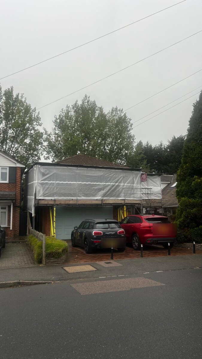 Armstrong Scaffolding temporary roof sheeted over a domestic garage in Petts Wood, with the driveway still in use underneath