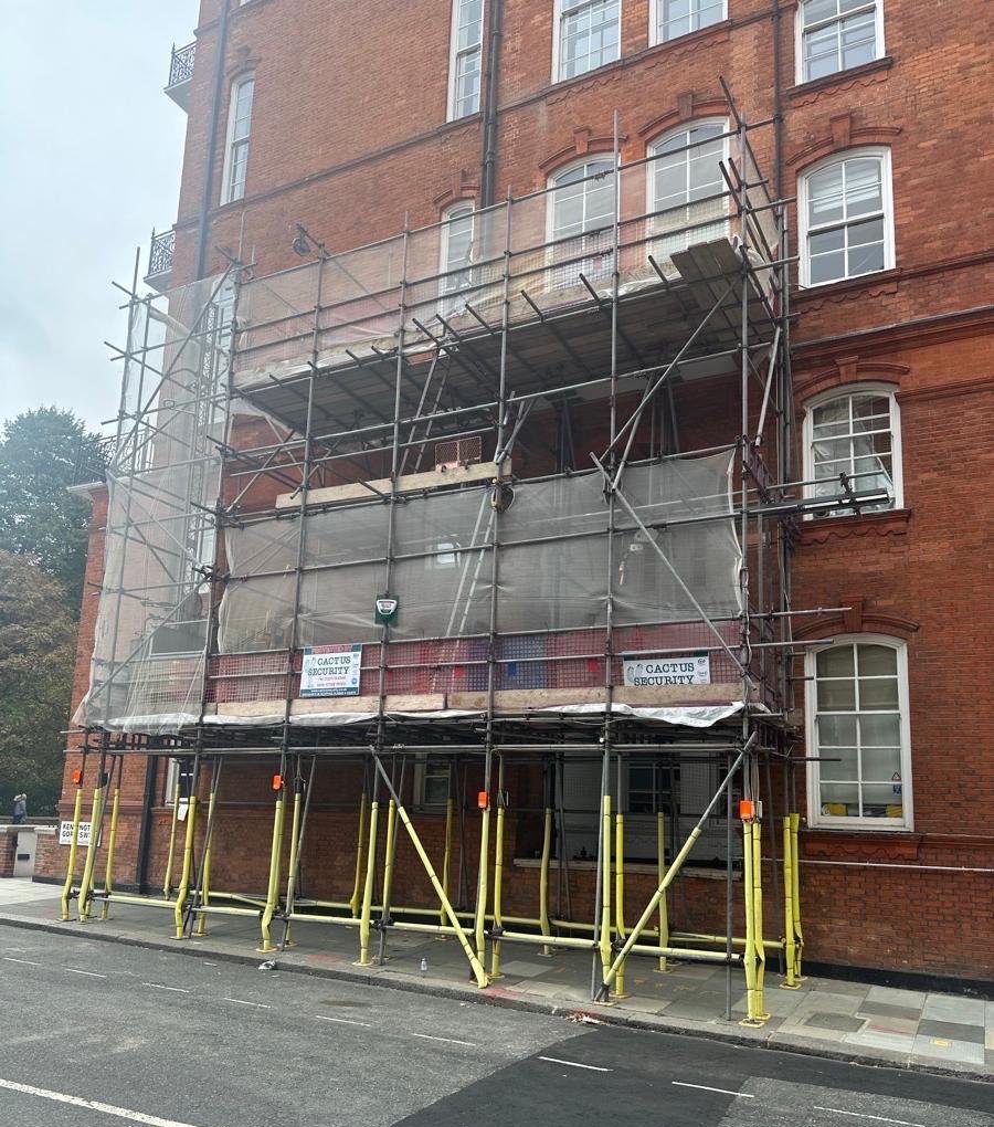 Armstrong Scaffolding pavement gantry with sheeted lifts and gin wheel hoist access at Albert Hall Mansions, Kensington