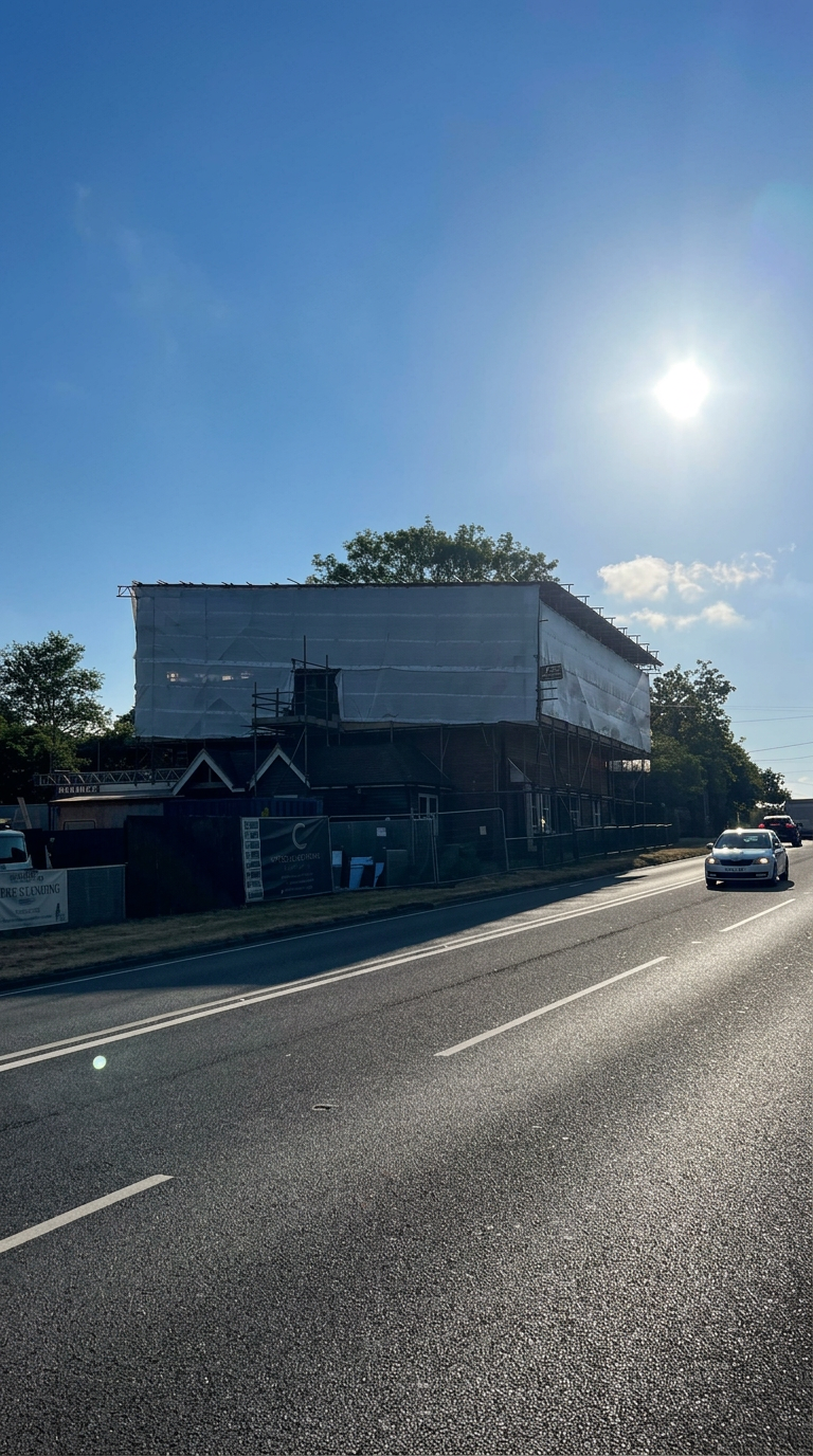 Fully sheeted temporary roof installed by Armstrong Scaffolding over a re-roofing contract in Horsham, West Sussex
